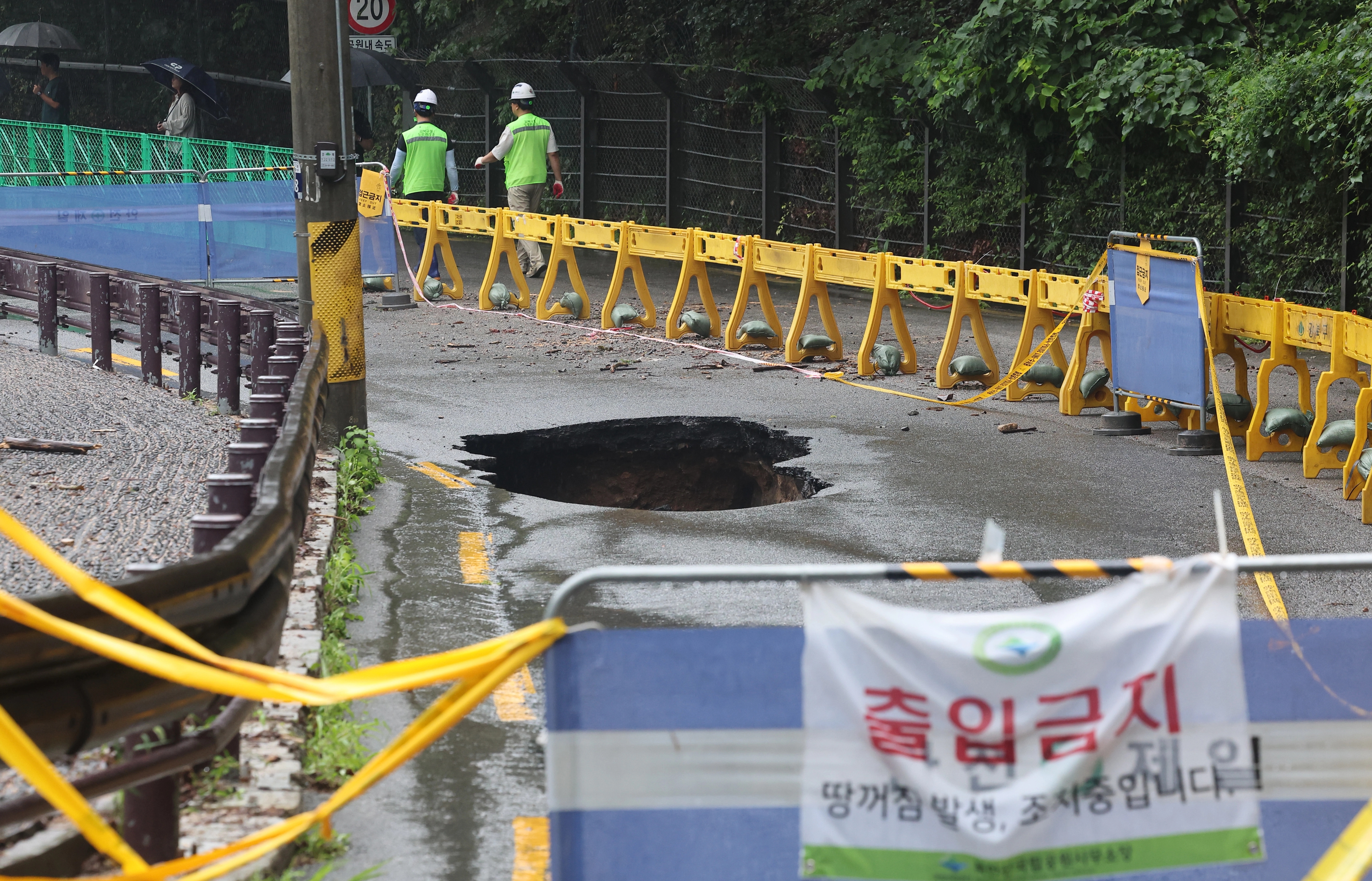  서울 곳곳에 호우주의보가 내린 13일 집중호우로 인한 땅 꺼짐 현상이 발생한 서울 강북구 도선사 진입로에 시민들의 접근을 막는 펜스가 설치돼 있다. 2025.8.13